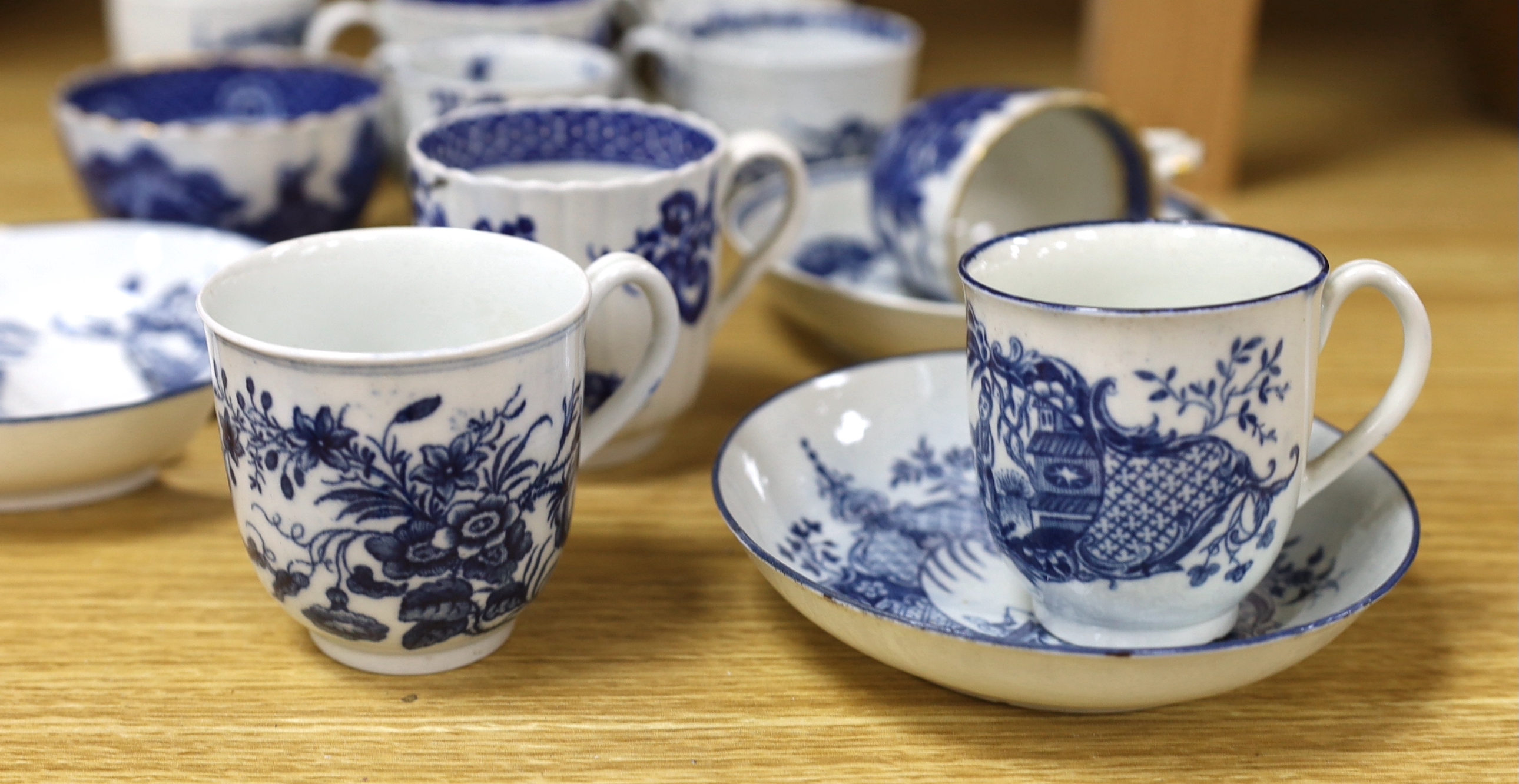 A collection of late 18th century Worcester, Caughley etc. blue and white coffee cups and saucers, the largest 12cm in diameter